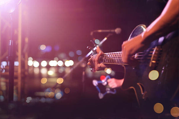 Guitarist on stage for background, soft and blur concept